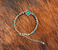 Navajo pearl, turquoise, and red spiny bracelet with silver flower